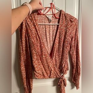 Burnt orange long sleeve shirt with floral pattern